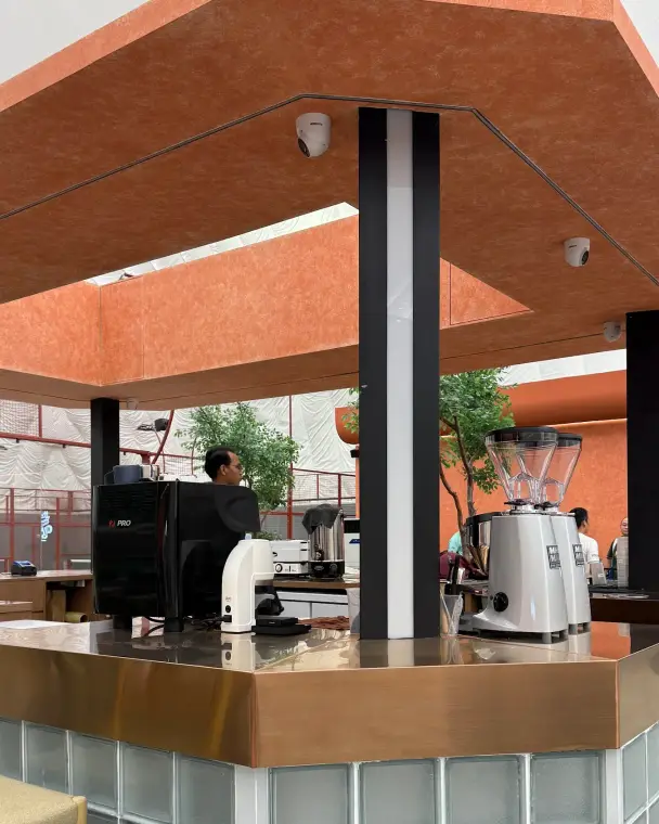 Barista at the espresso machine in the café kiosk