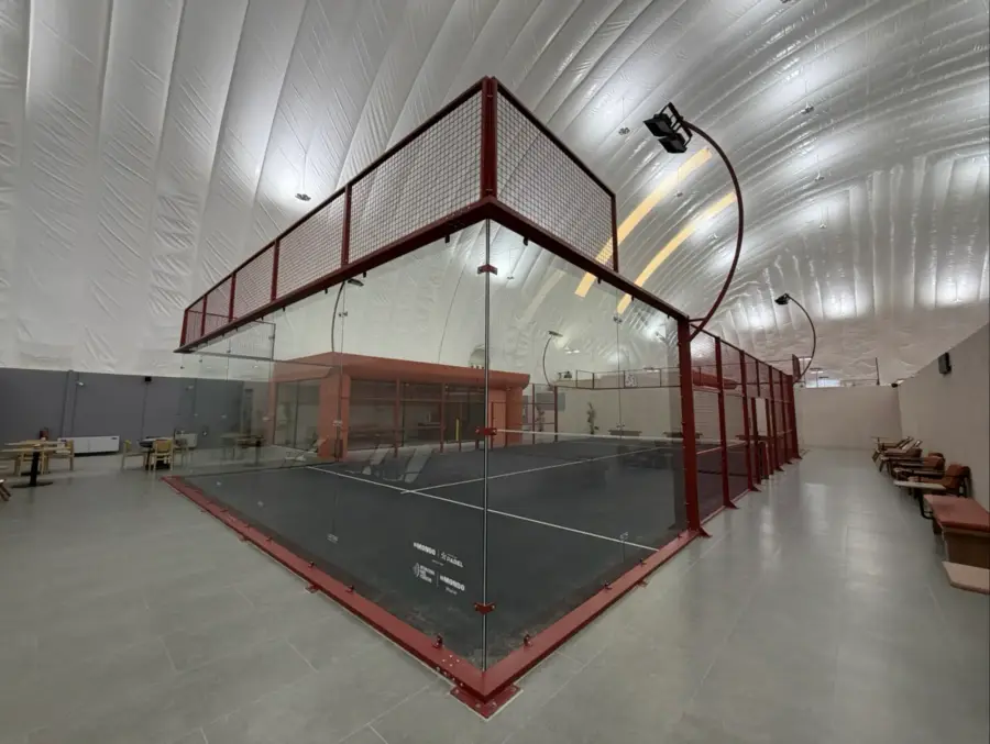 A glass court framed in red steel