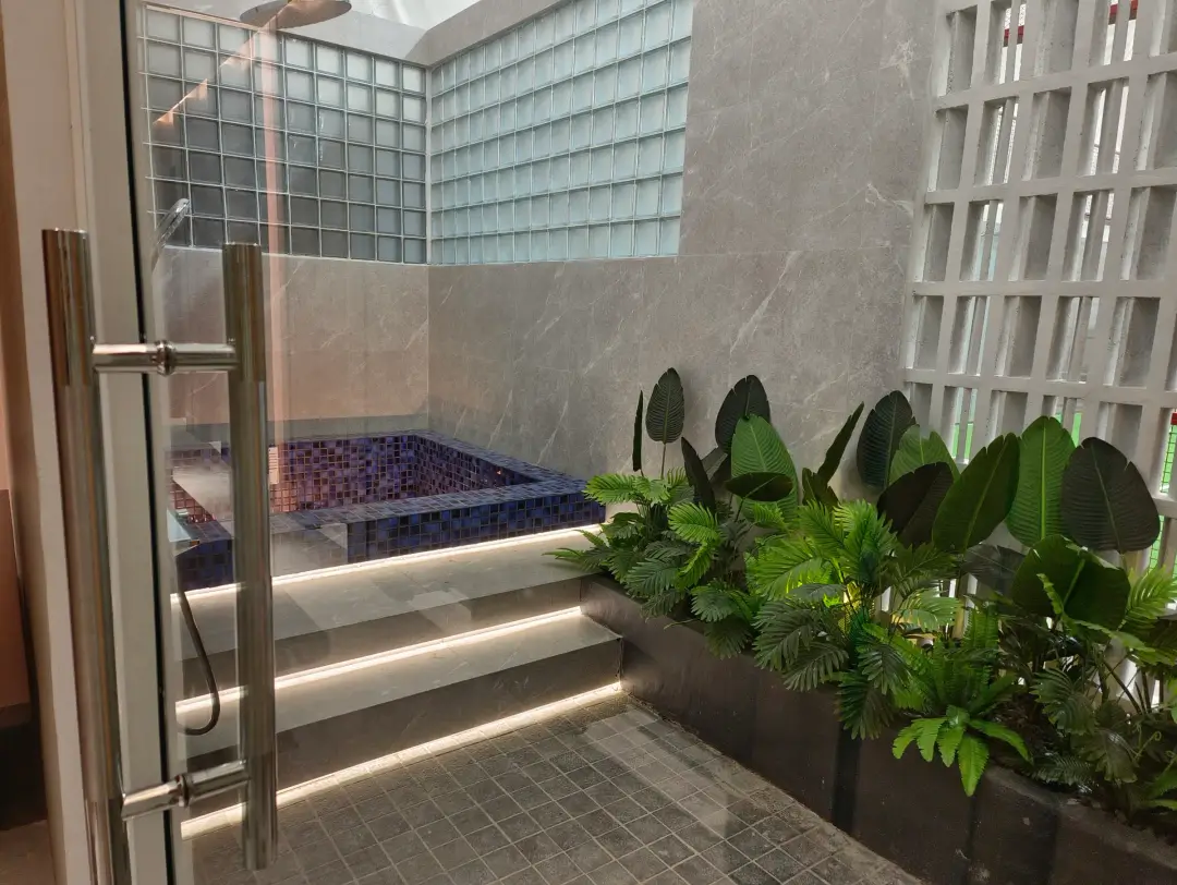 Tiled cold plunge pool with planting and glass blocks