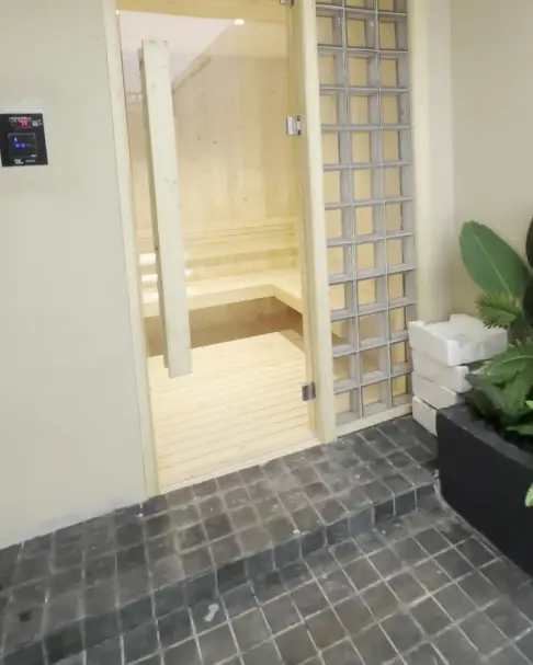 Timber sauna behind a glass door