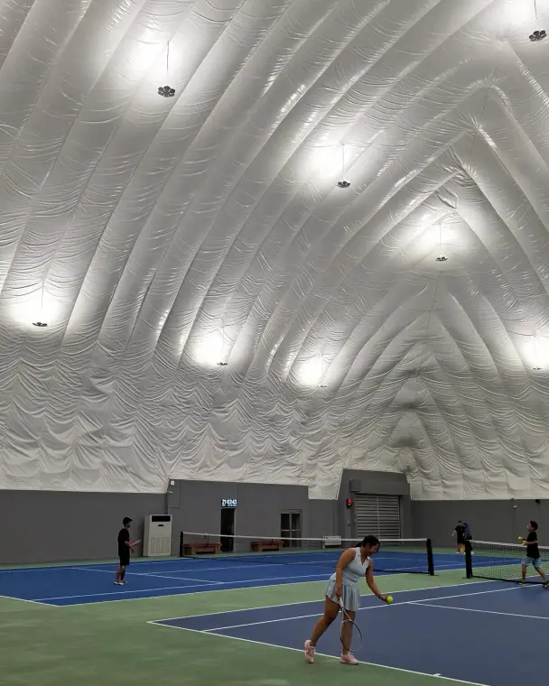 Players on the blue tennis court